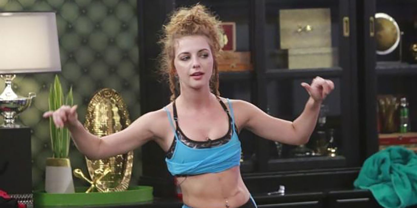 Raven from Big Brother wearing a crop top, hands out on either side.