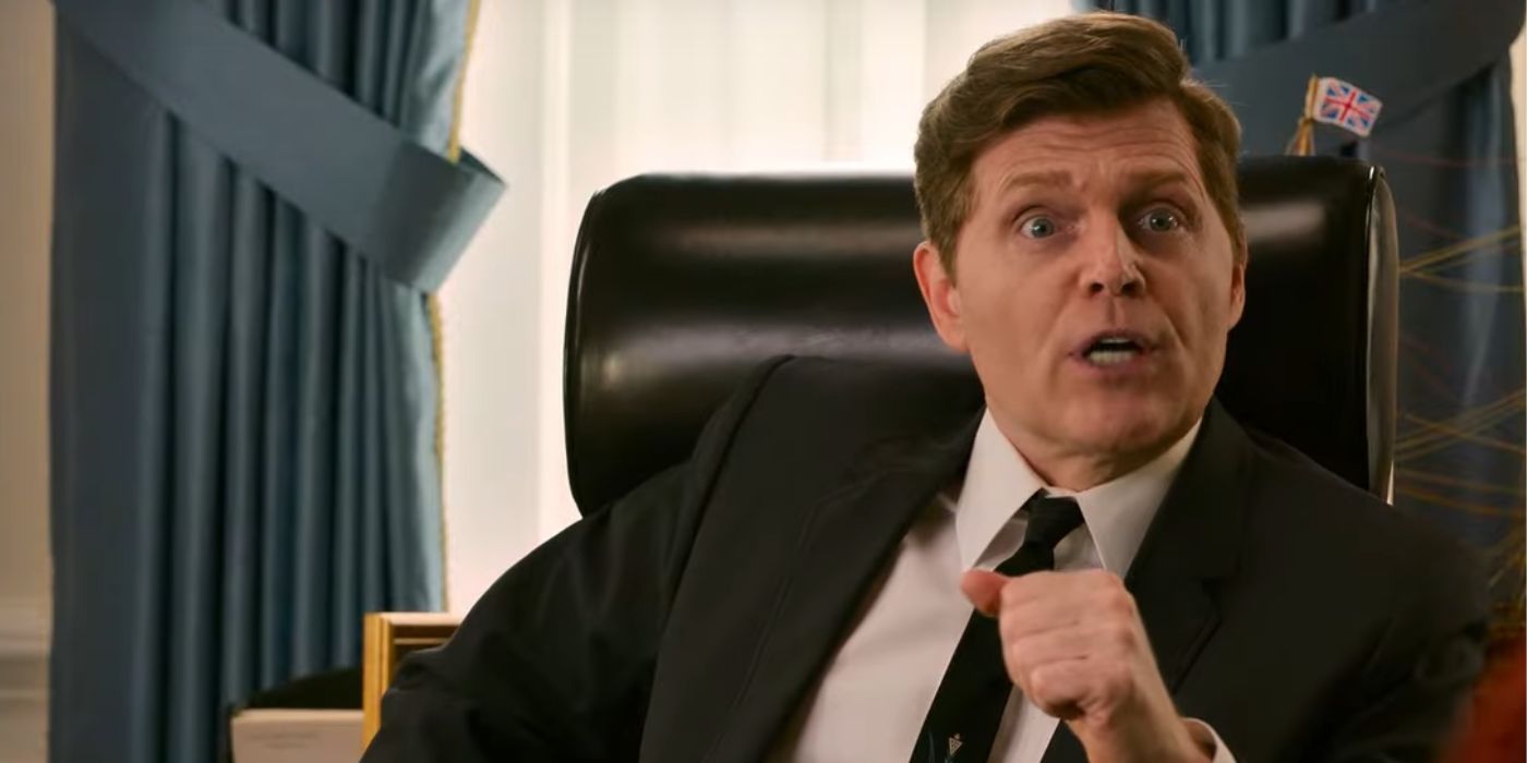 Bill Burr as JFK arguing from his desk in the oval office in Unfrosted.