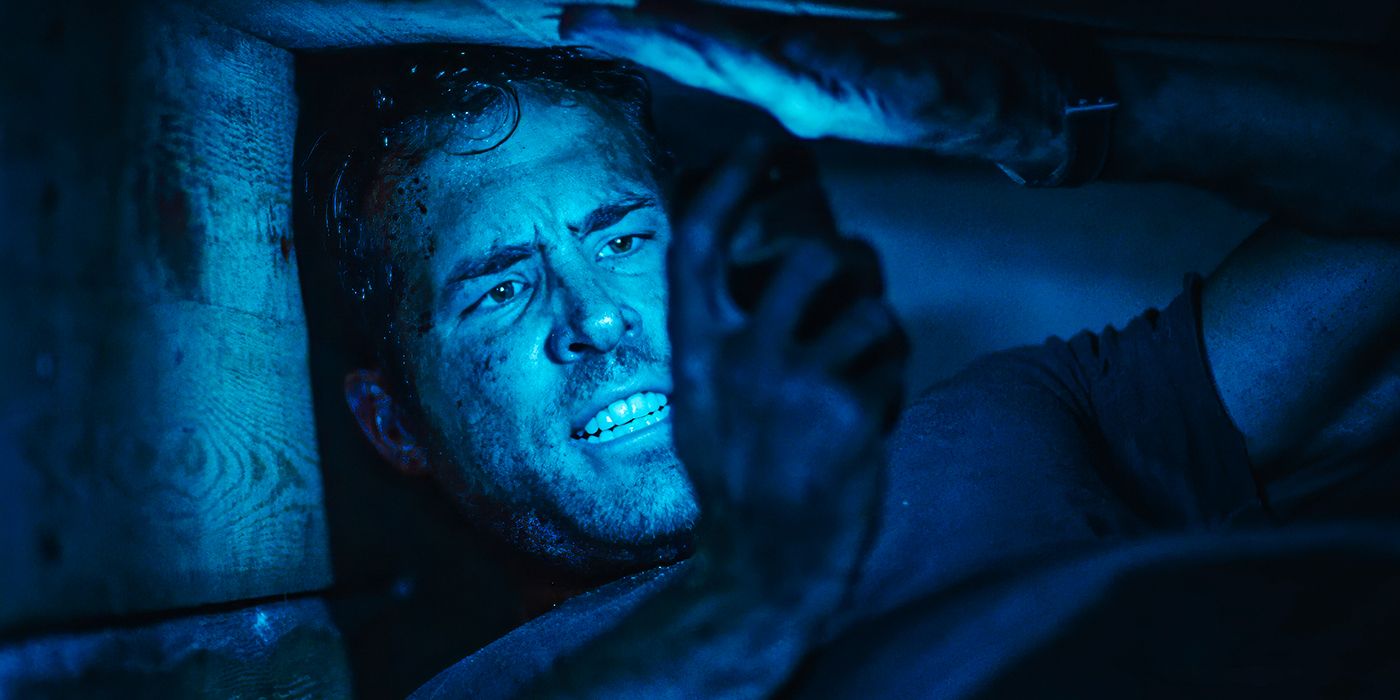 Ryan Reynolds as Pual Conroy looking at a phone while trapped in a coffin in Buried