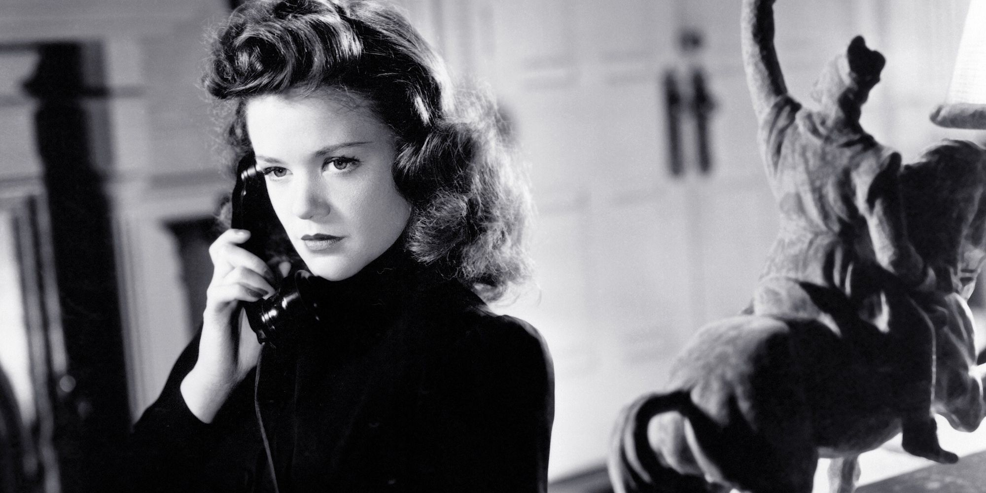 Black and white still of a woman on the phone in Cat People 