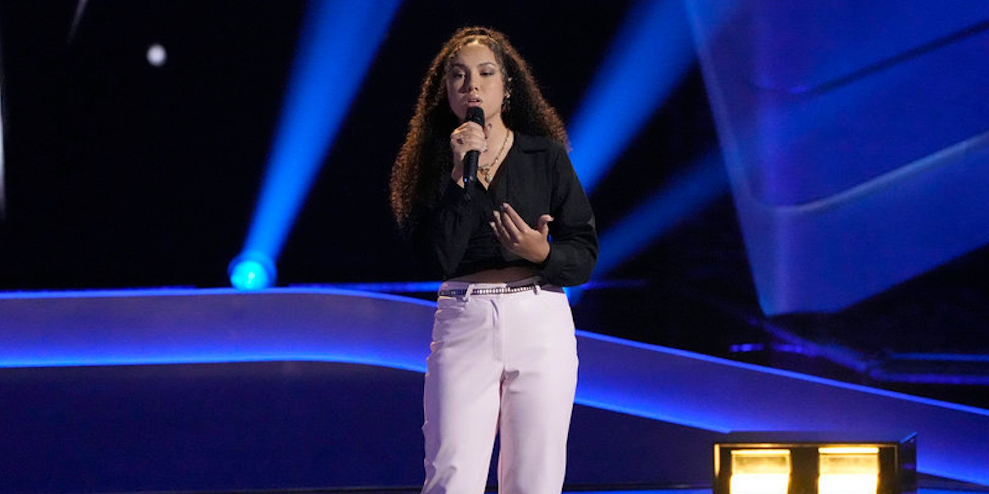 Serenity Arce auditions, singing into a mic, on 'The Voice'