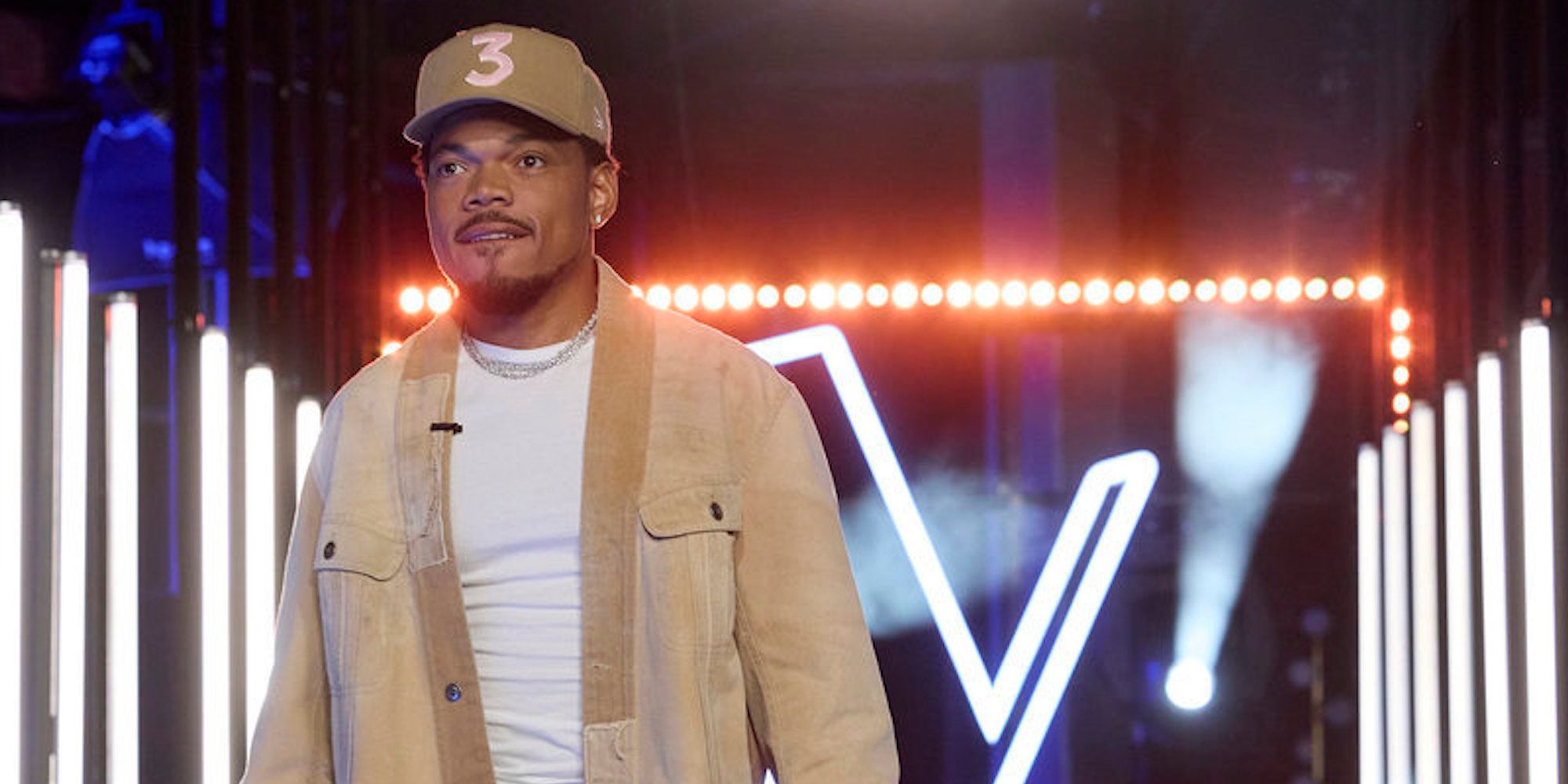 Promotional photo for 'The Voice' showing Chance the Rapper walking towards camera