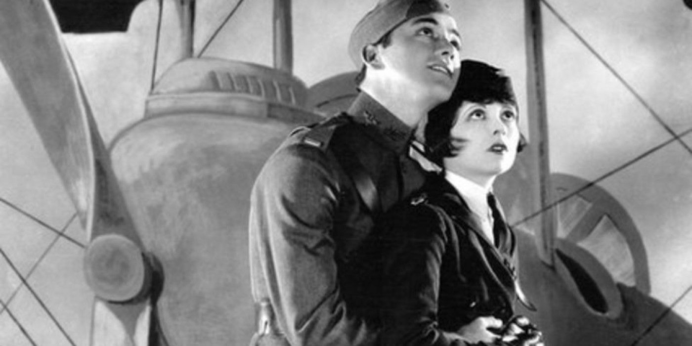 Charles "Buddy" Rogers and Clara Bow stand in front of airplane in 1927's 'Wings'