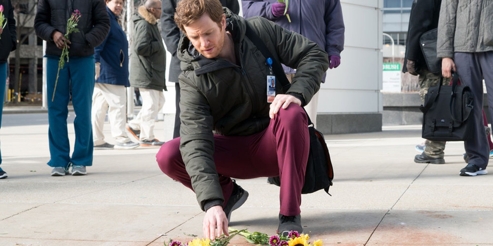 a man bending to down touching the ground