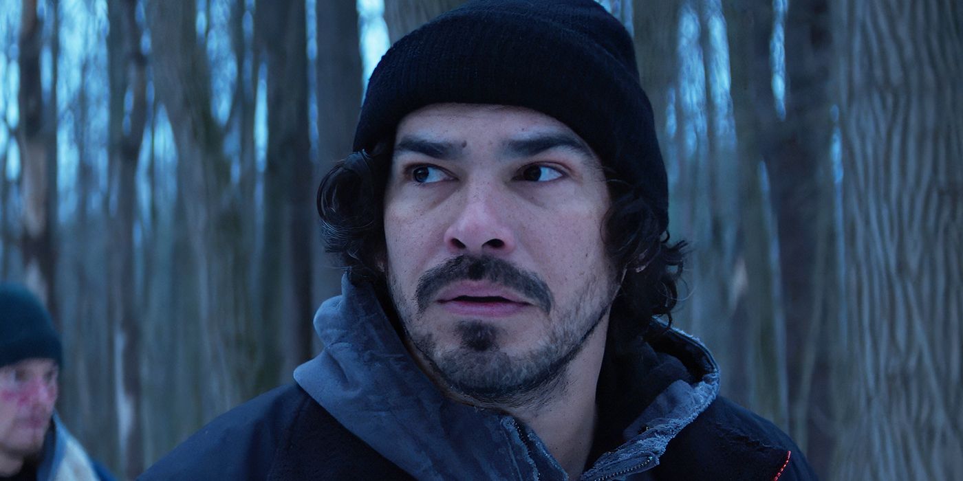Raúl Castillo as Billy standing in the woods in Cold Wallet. 