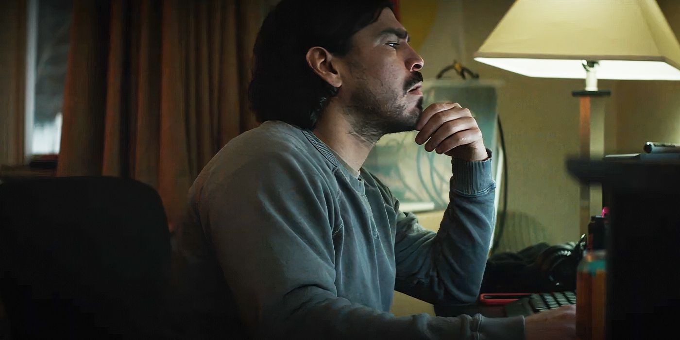 Raúl Castillo as Billy sitting at a computer looking concerned in Cold Wallet.