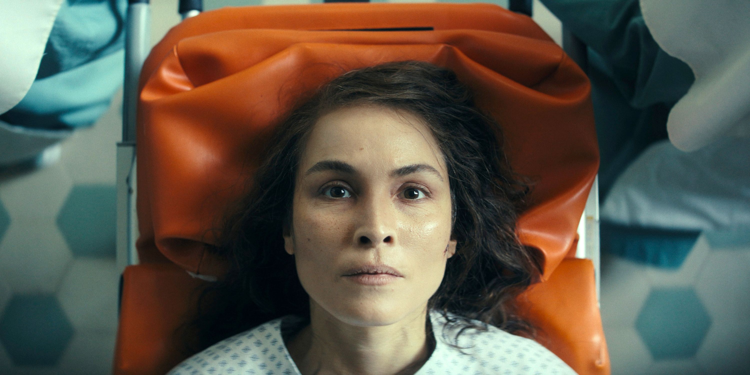 Noomi Rapace as Jo Ericsson on an orange gurney in Episode 8 of Season 1 of Constellation