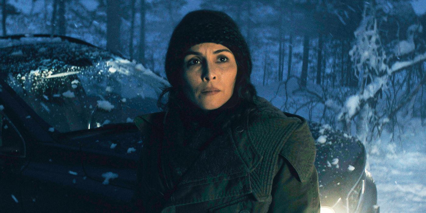 Noomi Rapace as Jo Ericsson standing in front of a car in a snowy forest setting in Constellation.