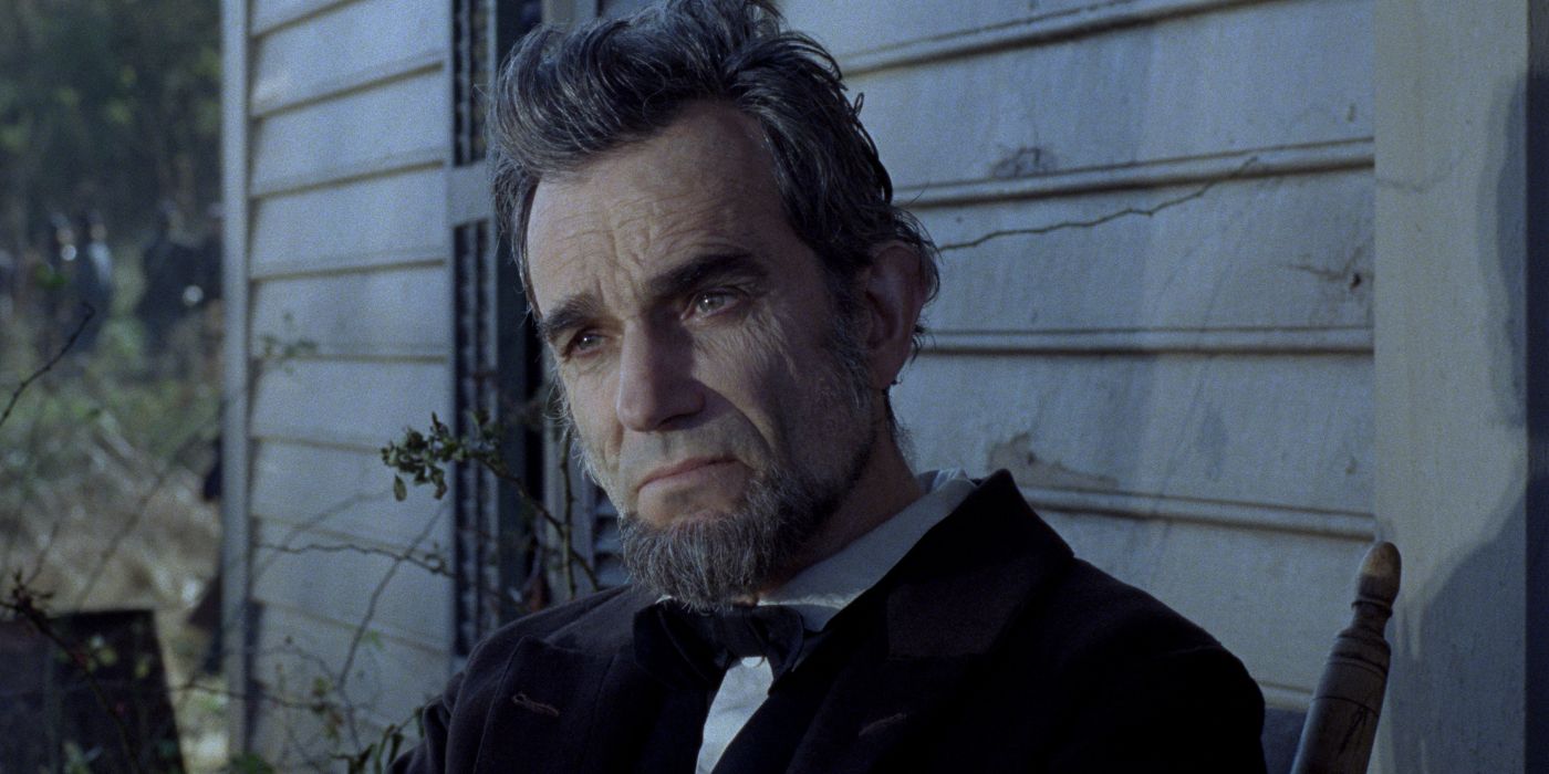 Daniel Day-Lewis sitting on a rocking chair on a porch as Abraham Lincoln in Lincoln