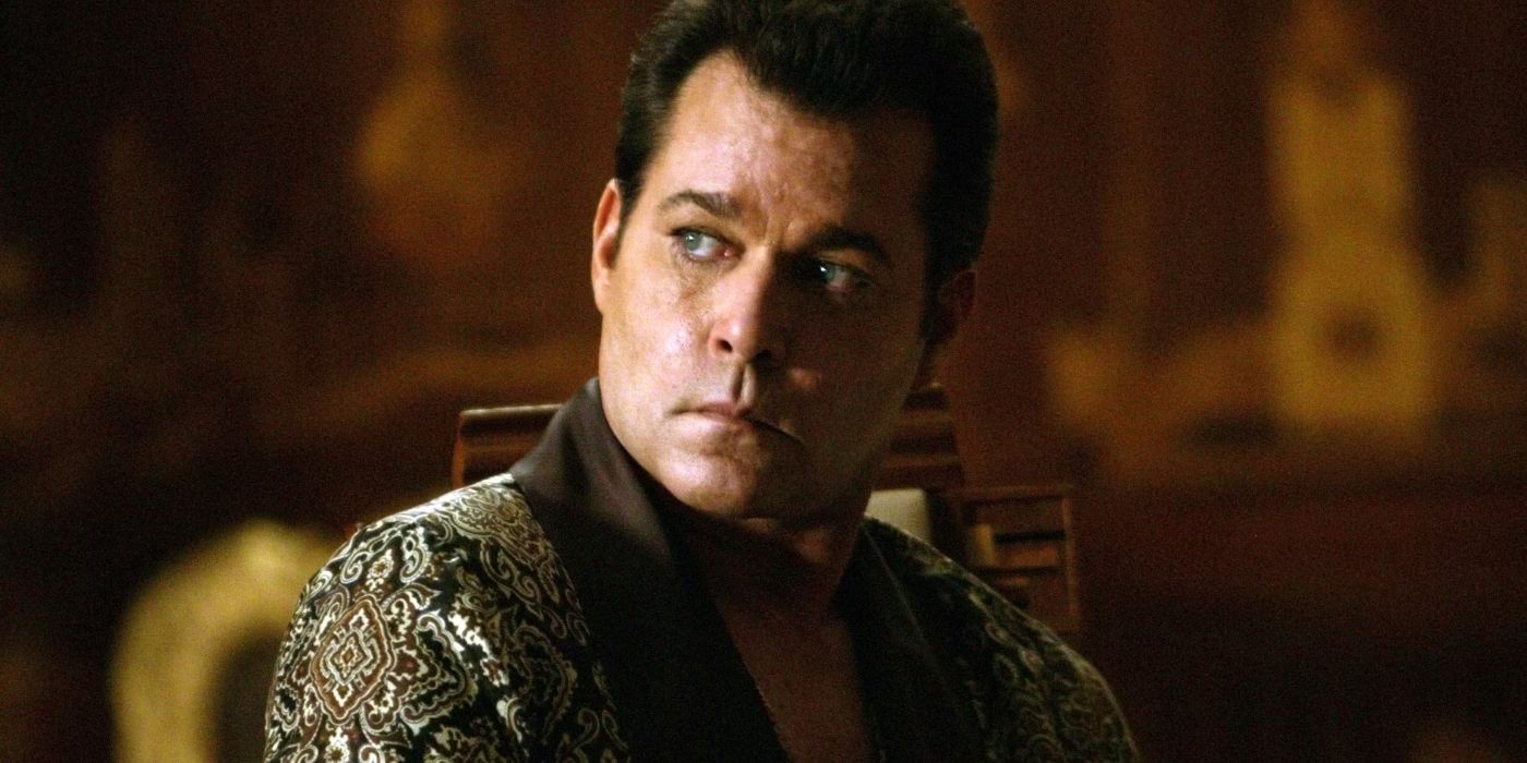 Dorothy Macha (Ray Liotta) sits in a fancy gown looking over his shoulder with a menacing scowl in 'Revolver' (2005)