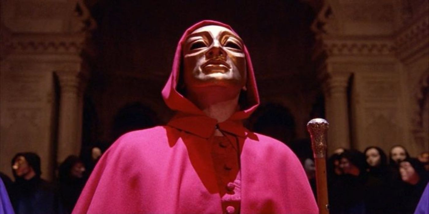 A man with a red cloak looking up in Eyes Wide Shut