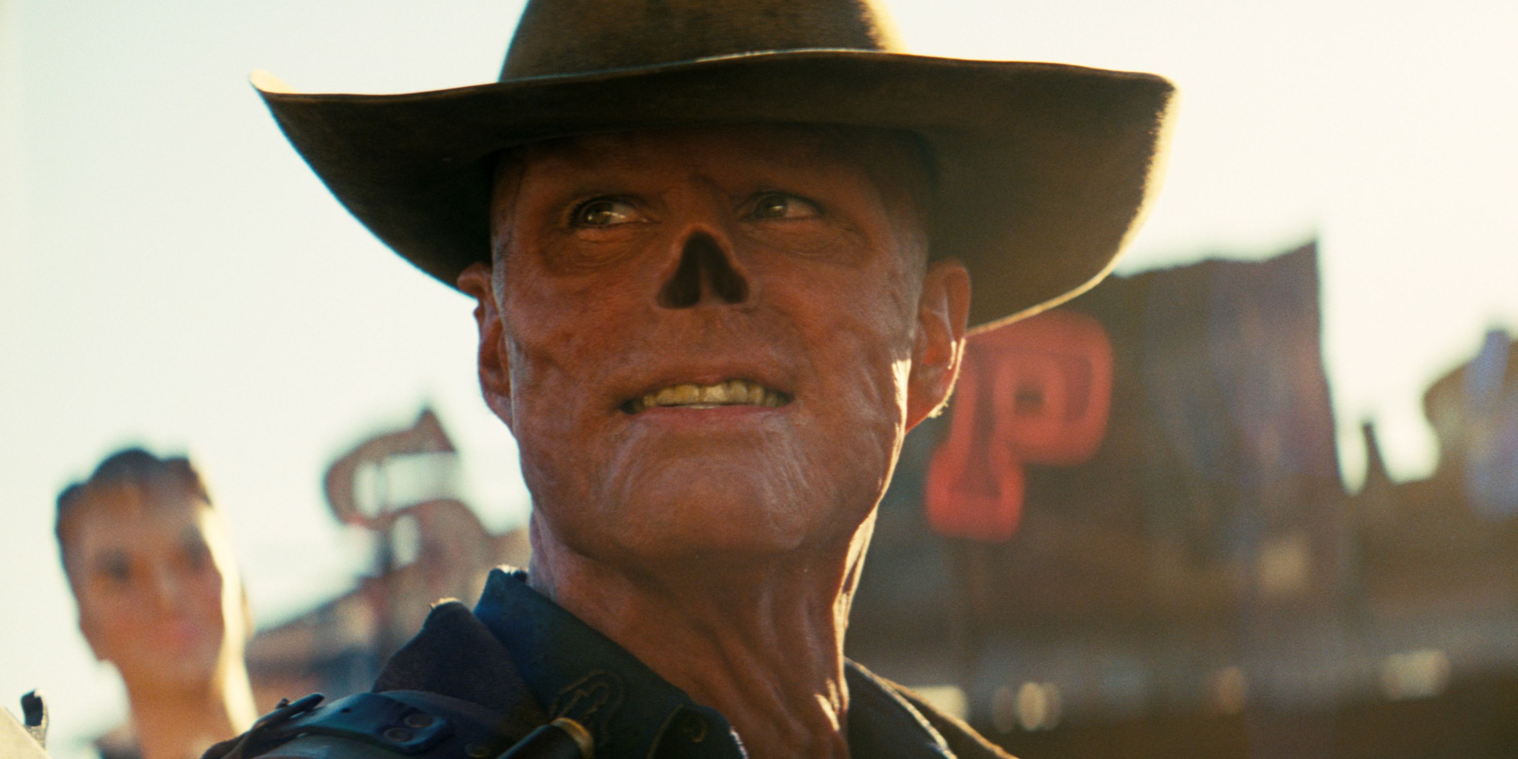 Walton Goggins as The Ghoul smiles at something off camera in the Prime Video series Fallout