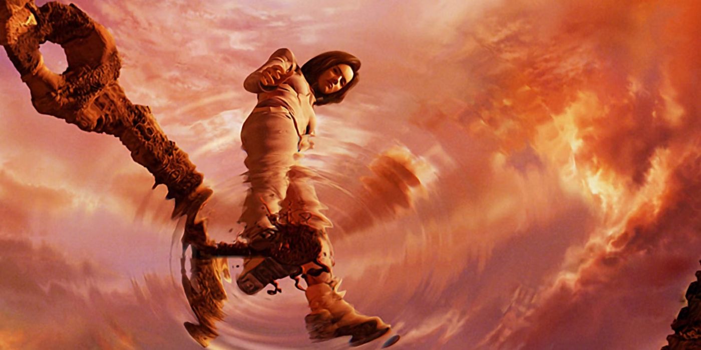 Aki Ross (Ming-Na Wen) standing on a watery surface and looking down, surrounded by a heavily orange sky and clouds, in Final Fantasy: The Spirits Within