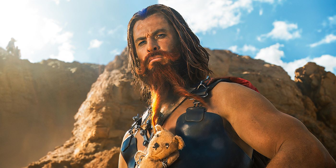 Chris Hemsworth standing below a cliff face in Furiosa: A Mad Max Saga