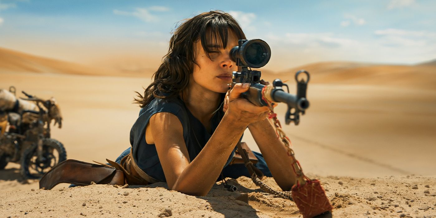 Charlee Fraser aims a sniper rifle in the desert in Furiosa: A Mad Max Saga
