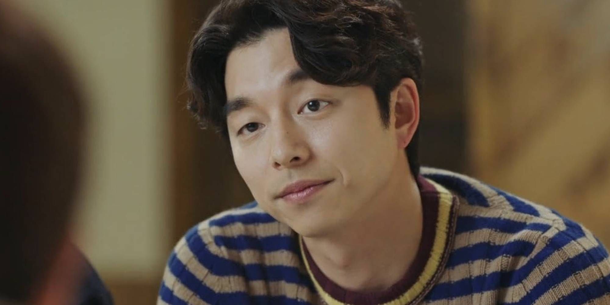 A close up of Gong Yoo smirking in Goblin.