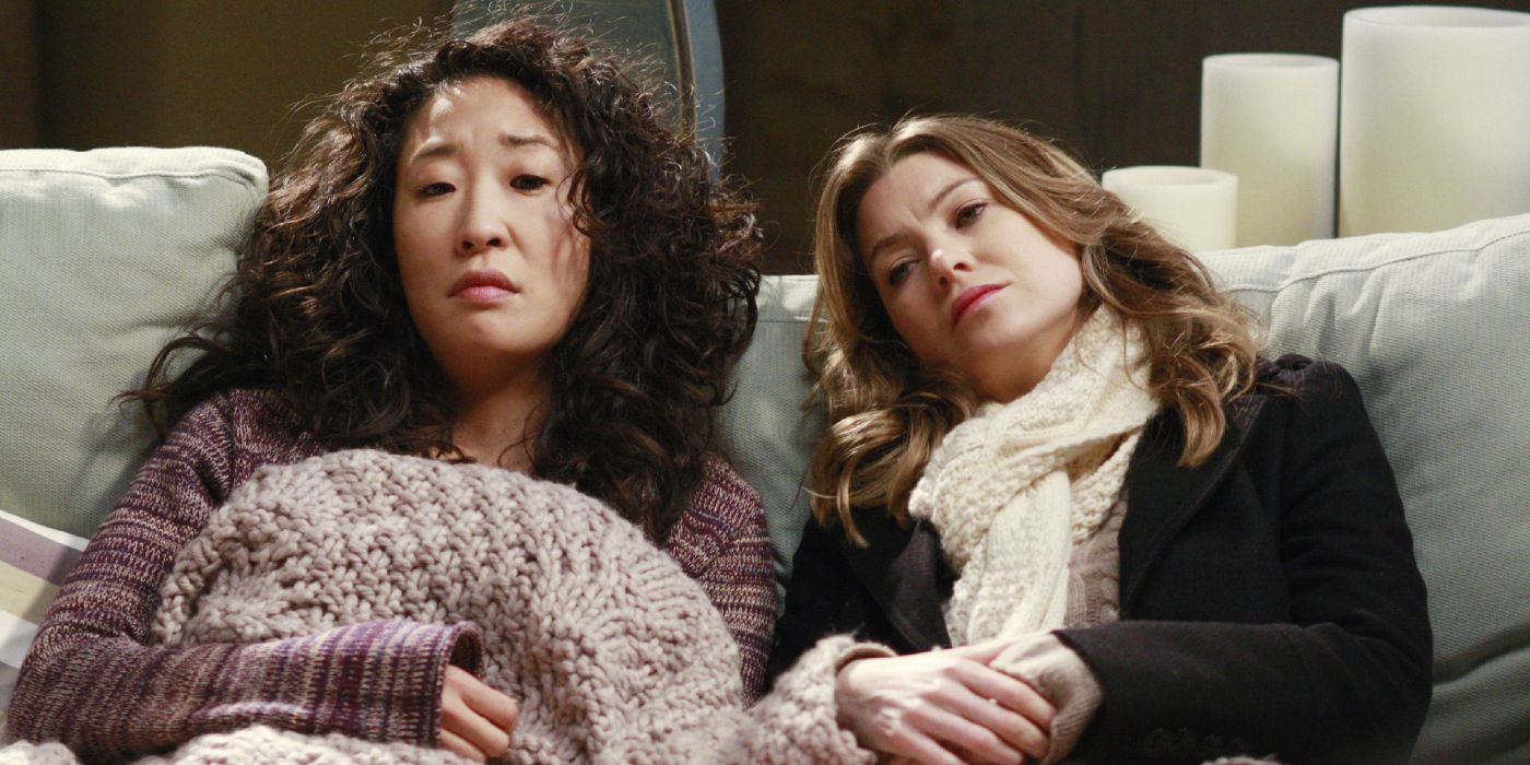 Sandra Oh and Ellen Pompeo slumped on the couch in Grey's Anatomy as Cristina and Meredith