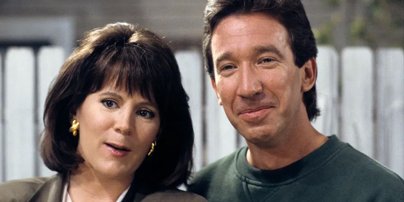 Patricia Richardson and Tim Allen standing in front of a white fence in Home Improvement