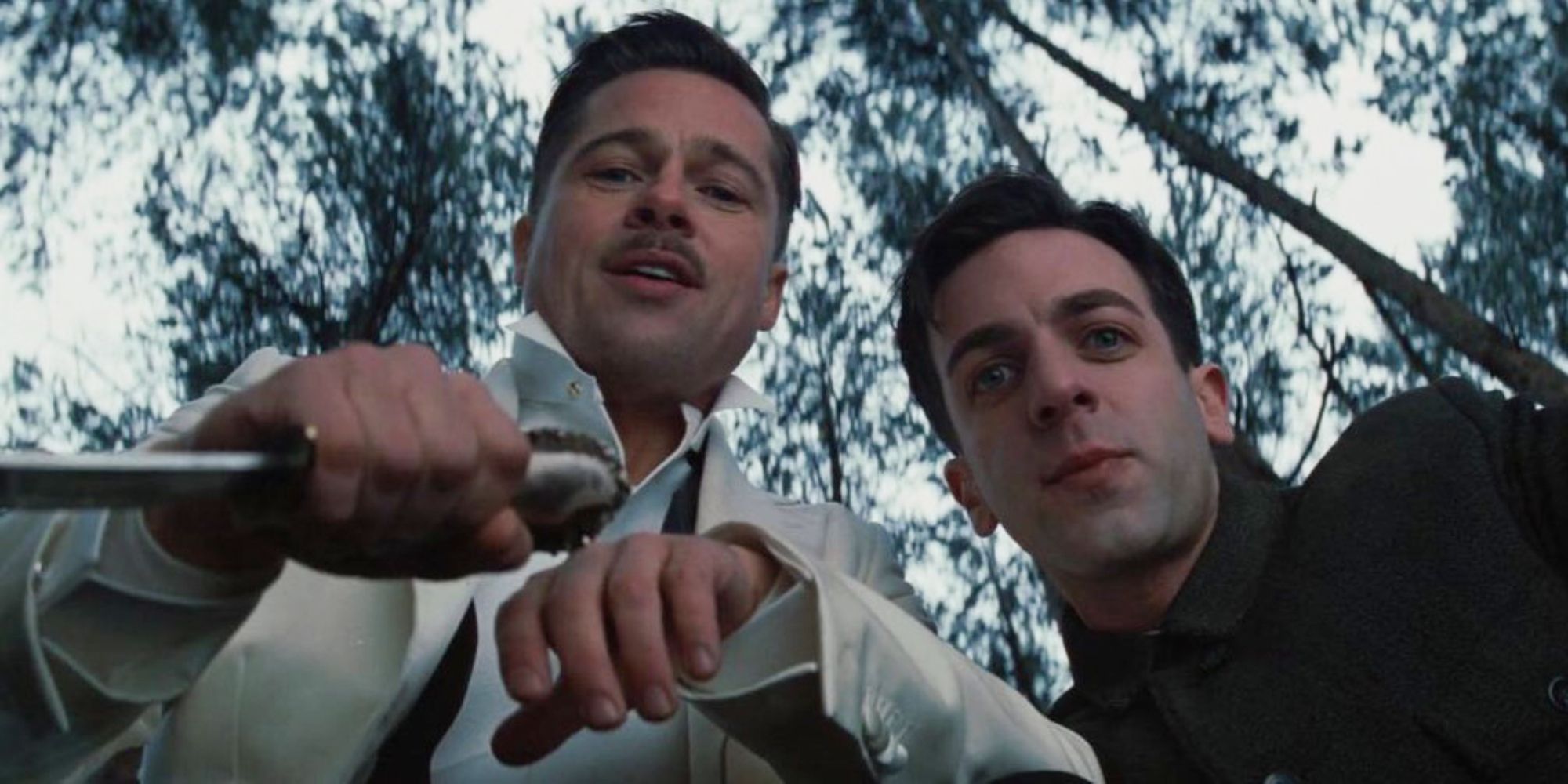Aldo and Utivich looking down at something and smiling in Inglourious Basterds