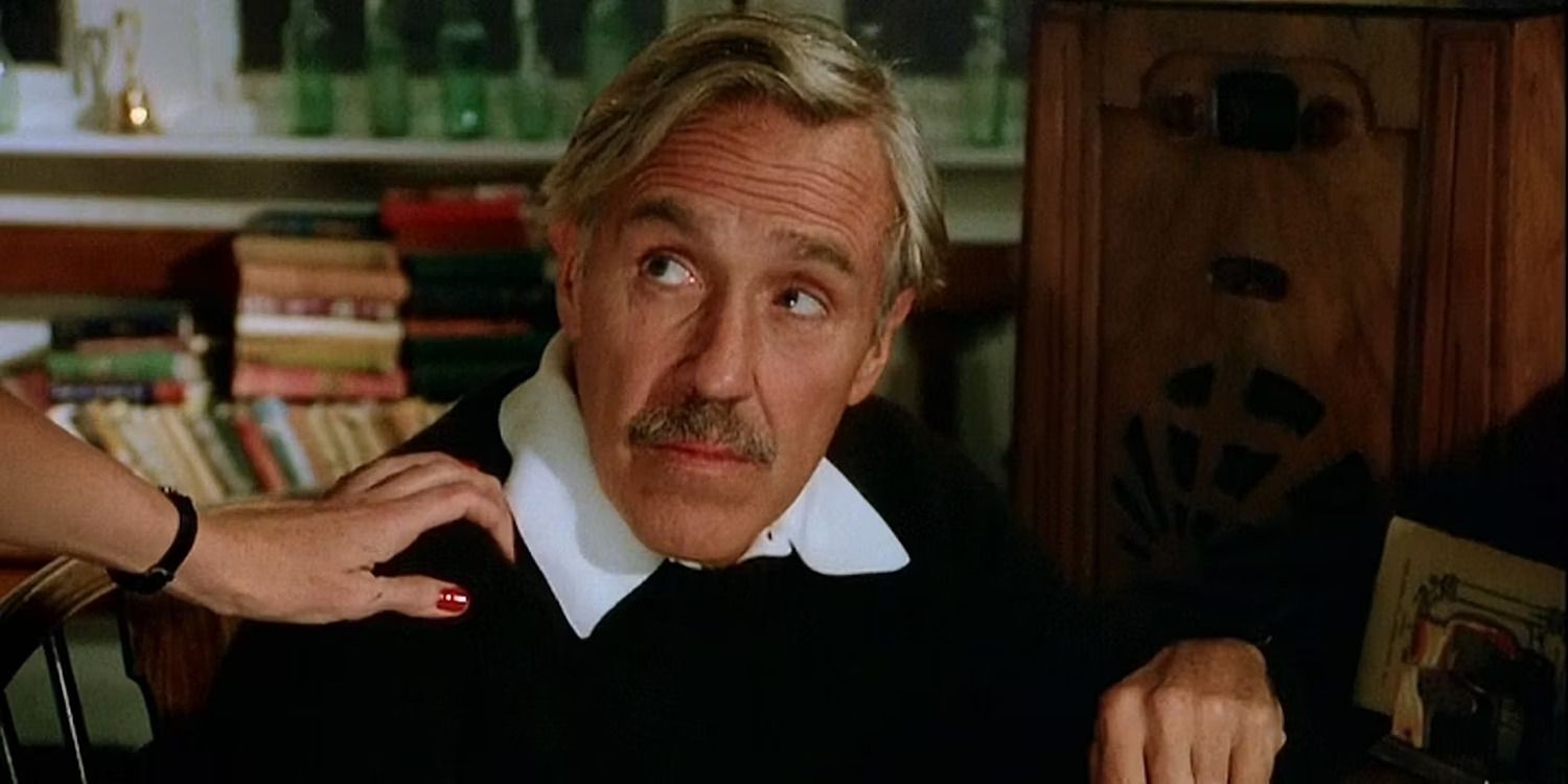 woman&rsquo;s hand touching the arm of a man with a moustache, who looks over