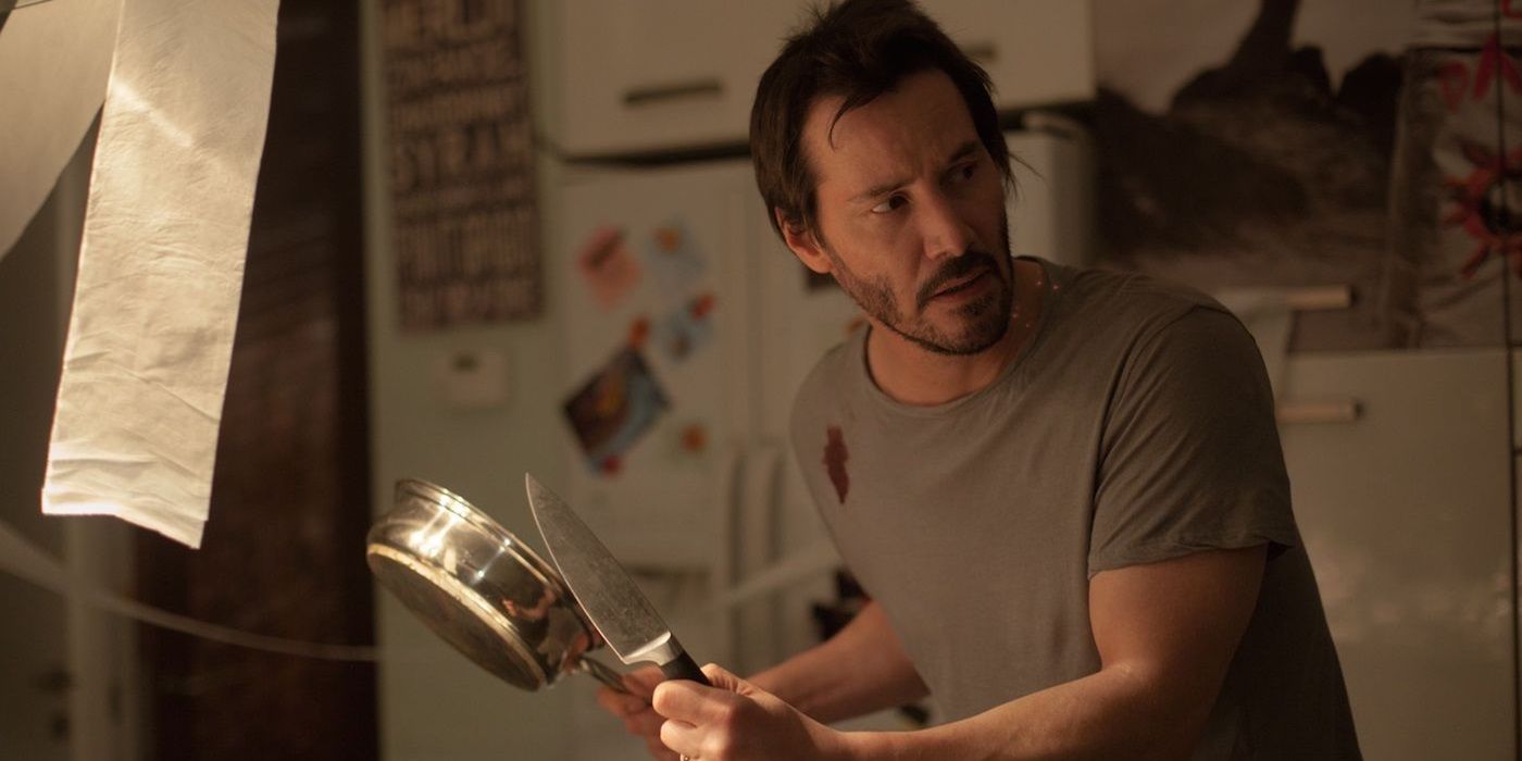 Keanu Reeves as Evan holding a pan in Knock Knock