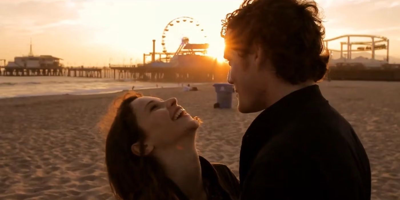 Felicity Jones as Anna and Anton Yelchin as Jacob laughing together on a beach in Like Crazy