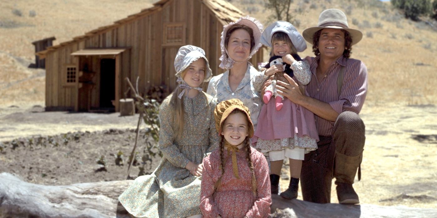 The Ingalls family smile outside their home on Little House on the Prairie.