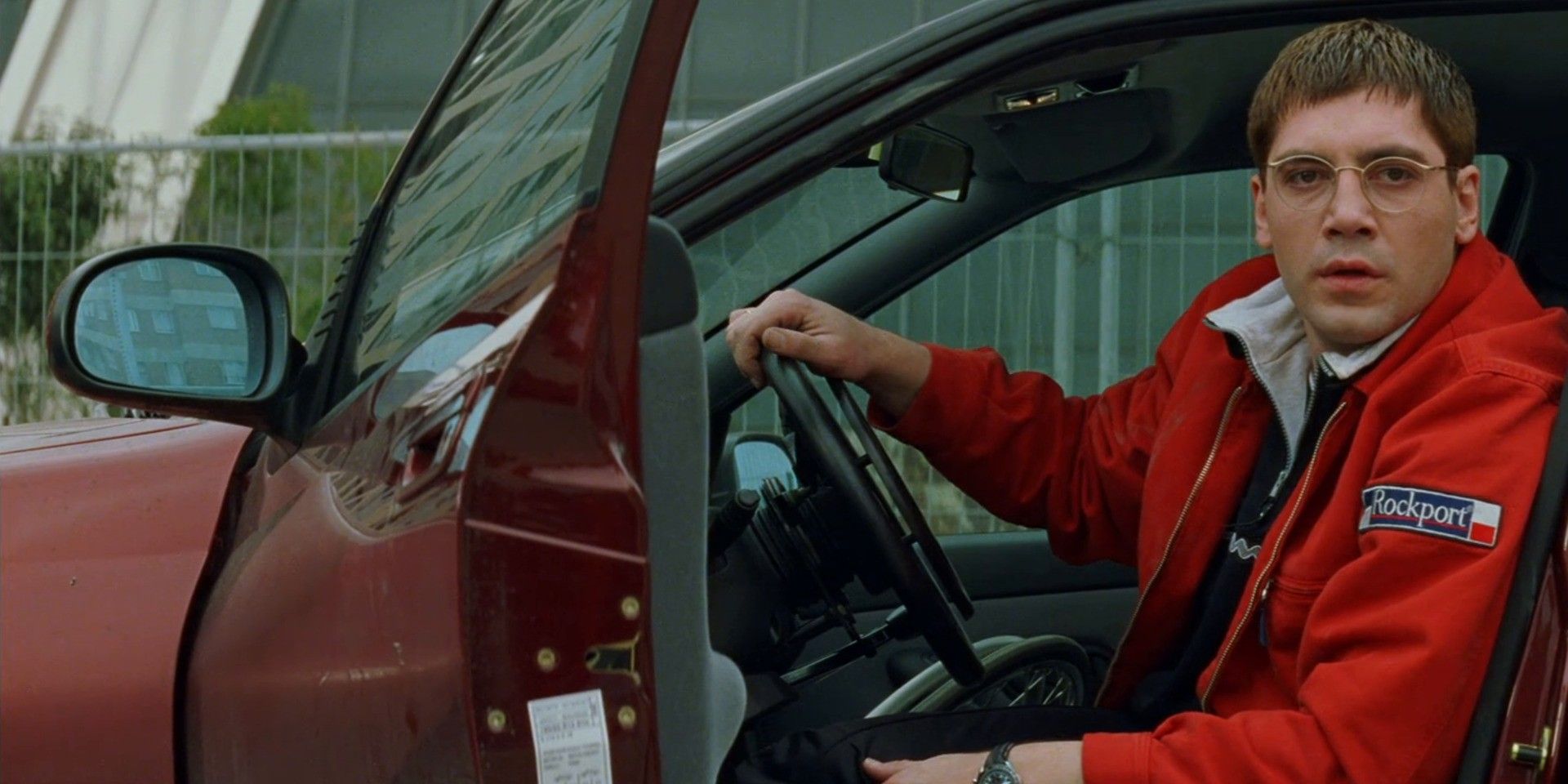 A still from Live Flesh featuring Javier Bardem as David de Paz in a red car