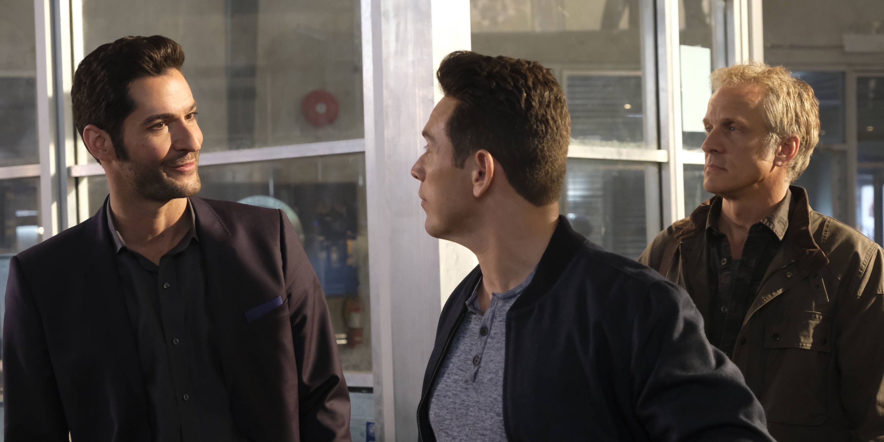 Three men talking in a police station