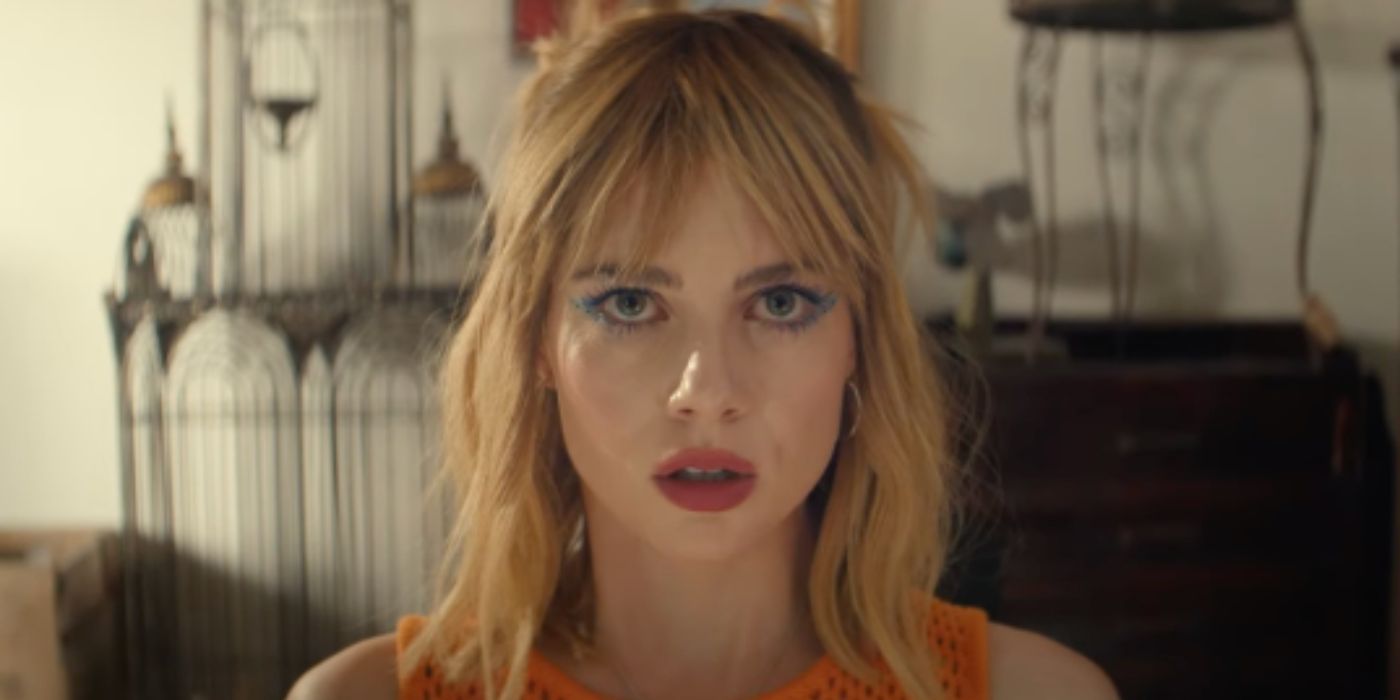 Lucy Boynton staring at the camera with blue eye makeup in 'The Greatest Hits'