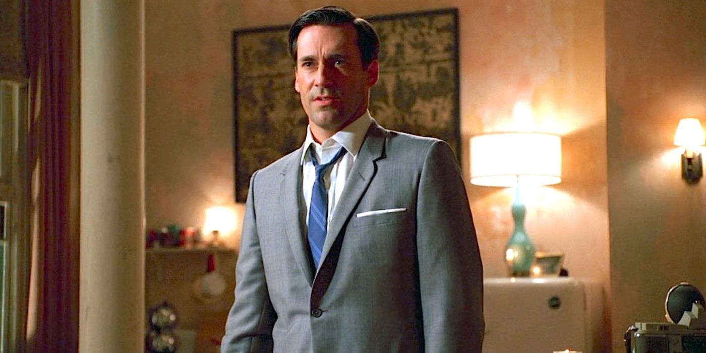 Don Draper stands in a quaint bedroom with several lamps on, giving an intense look to someone as he speaks.