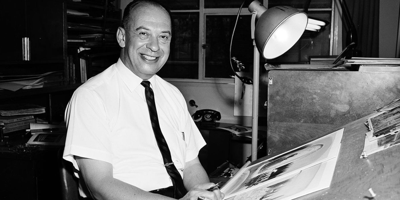 Marc Davis working at his desk while smiling.
