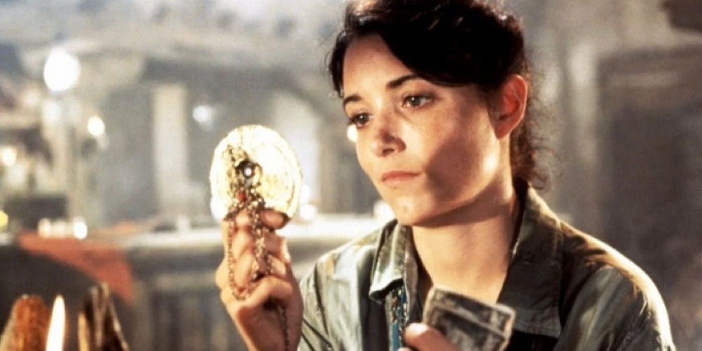 Karen Allen as Marion Ravenwood looking at a medallion in Raiders of the Lost Ark