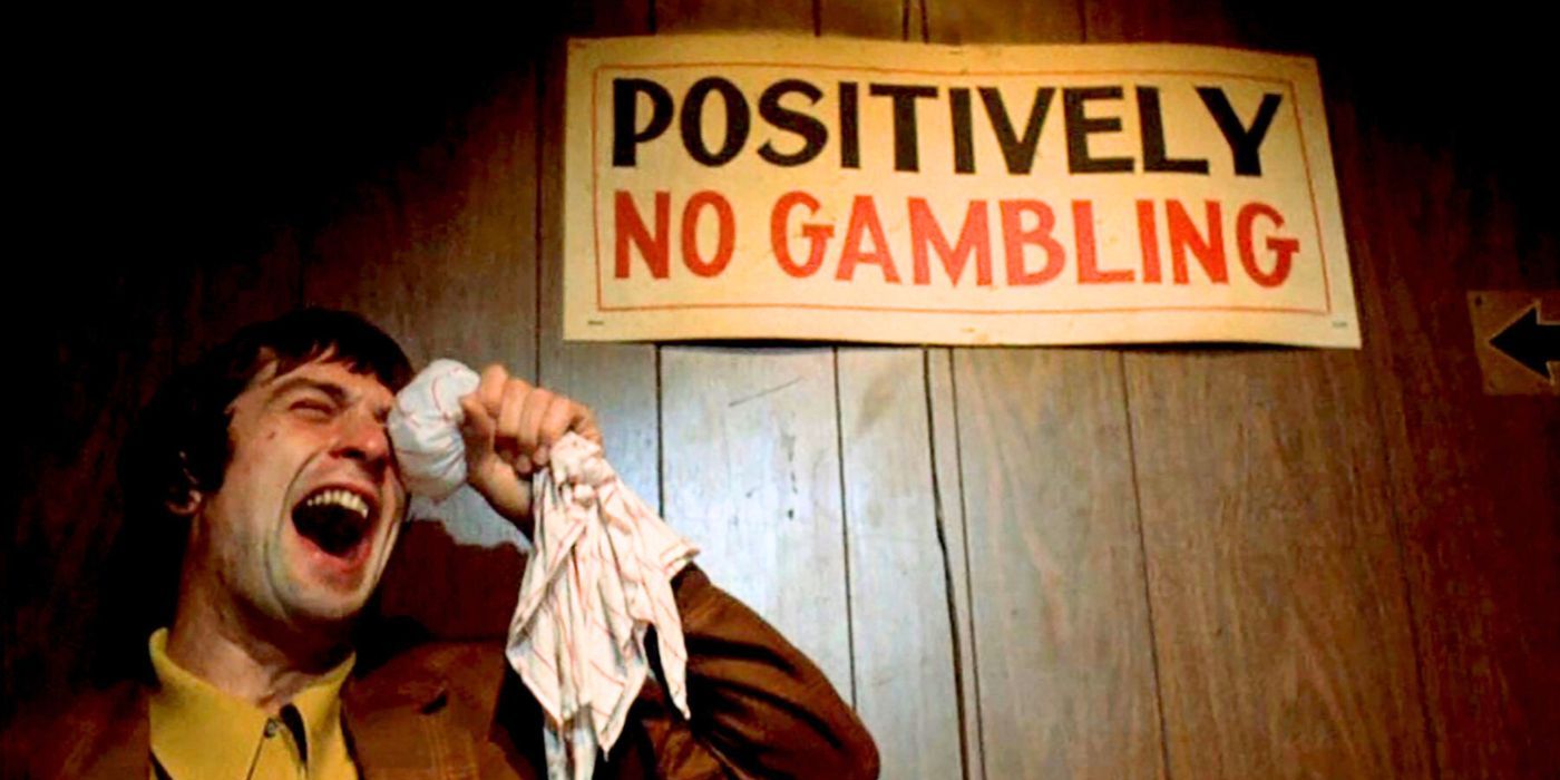 Robert De Niro holding a cloth of ice to his eyes in front of a &ldquo;positively no gambling&rdquo; sign in Mean Streets