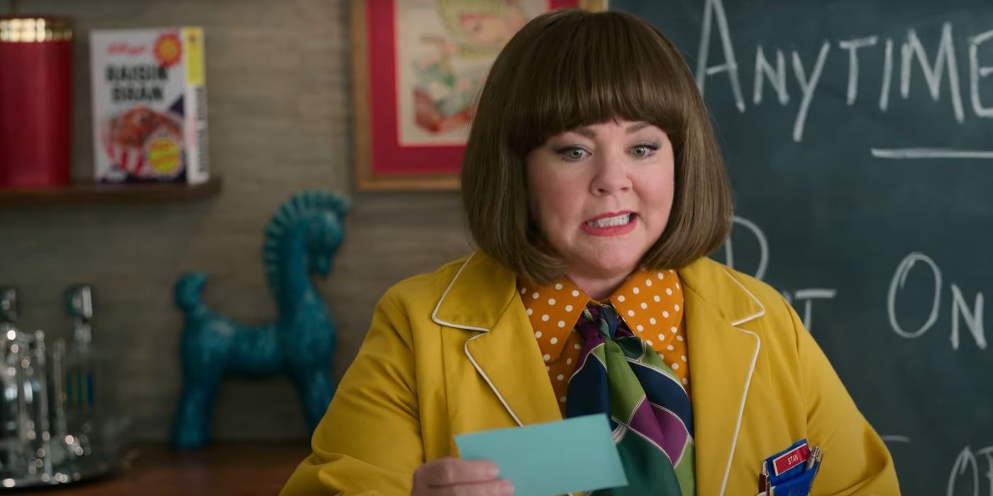 Melissa McCarthy as Donna Stankowski, holding a card in Unfrosted.