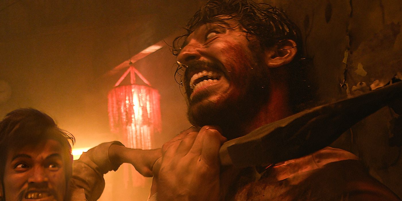 Dev Patel fighting a man and grinning manically in Monkey Man