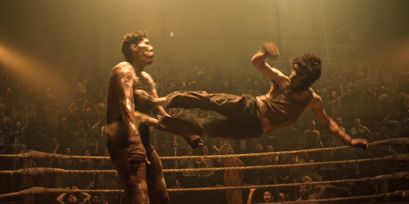 Dev Patel kicks a man in the chest with both feet in “Monkey Man”