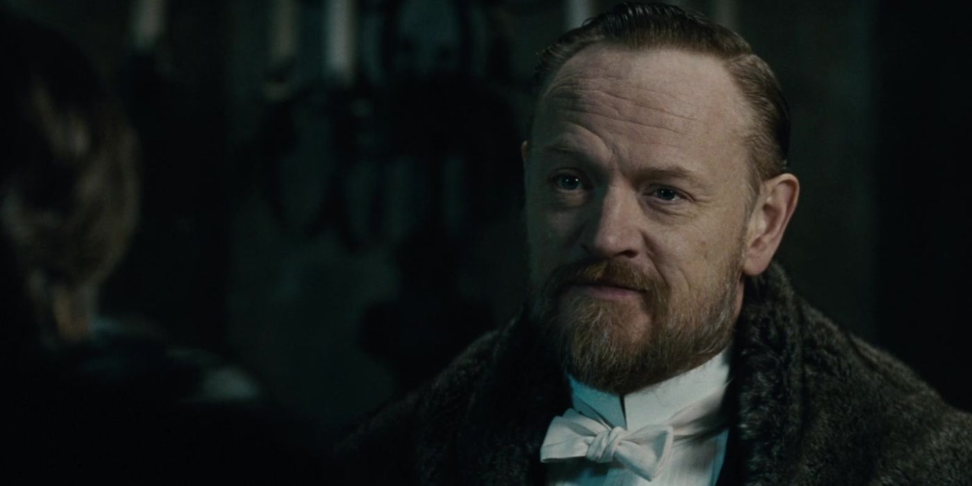 Professor Moriarty (Jared Harris) wears a fur coat and a white bowtie as he stares as Sherlock Holmes (Robert Downey Jr.) in 'Sherlock Holmes: A Game of Shadows' (2011)