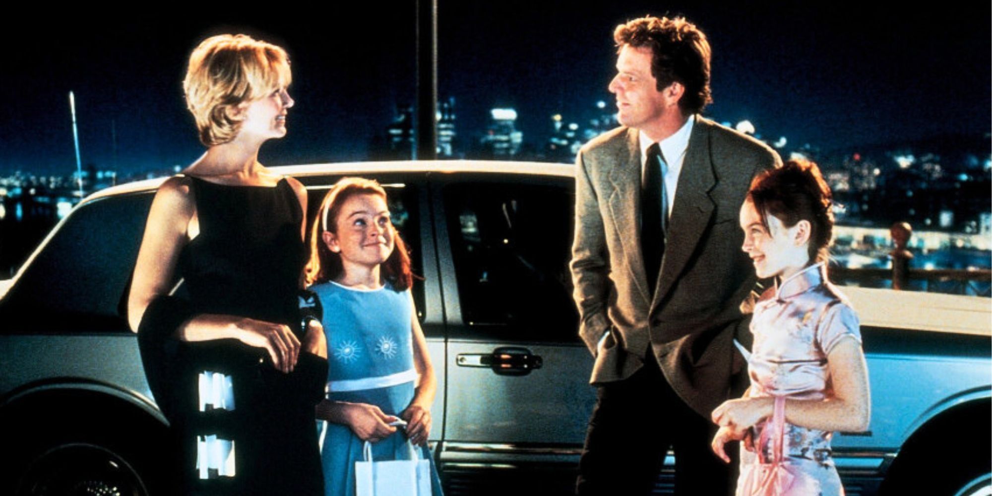 Natasha Richardson, Lindsey Lohan and Dennis Quaid standing next to each other in front of a limo in The Parent Trap (1998)