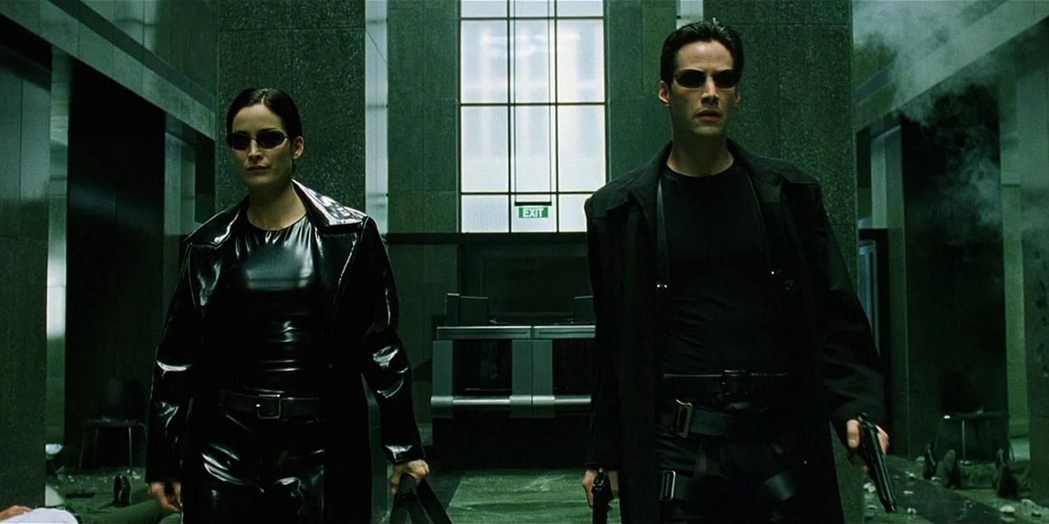 Neo (Keanu Reeves) and Trinity (Carrie-Ann Moss) walk through the lobby in 'The Matrix'
