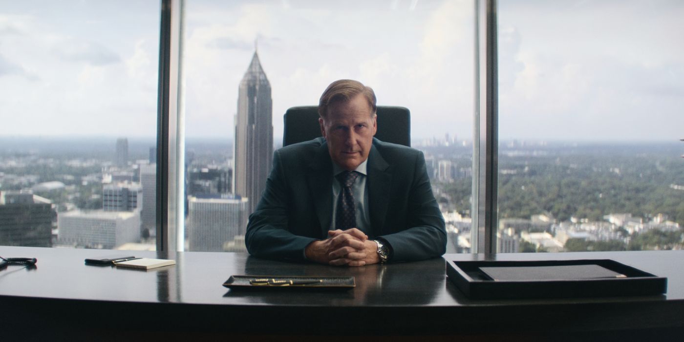 Jeff Daniels wears a suit and sits behind a desk in 'A Man in Full' 
