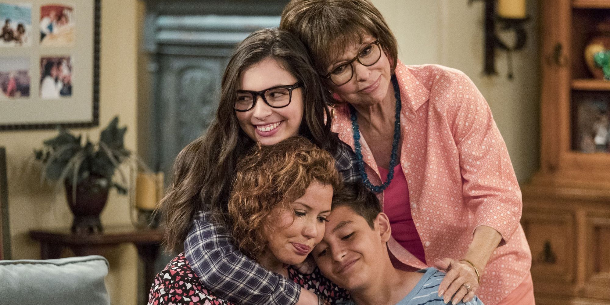 Penelope, Alex, Elena, and Lydia from One Day At A Time hugging