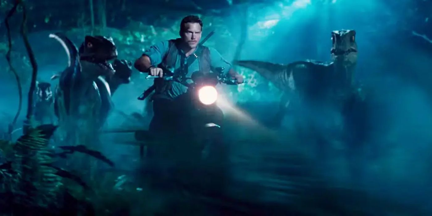 Owen rides a motorcycle through the jungle with his posse of velociraptors in 'Jurassic World'