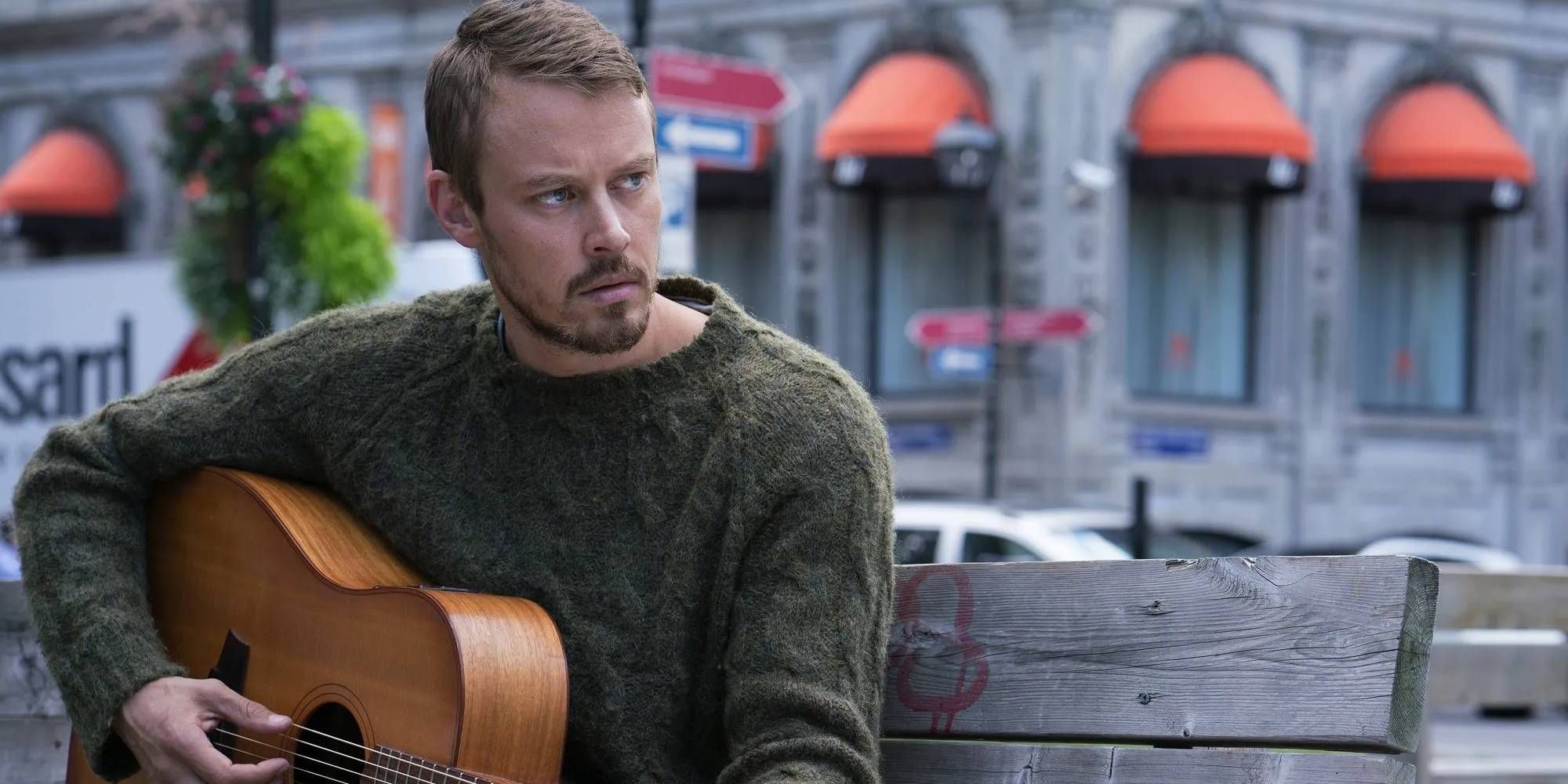 Michael Dorman in Patriot playing the guitar.