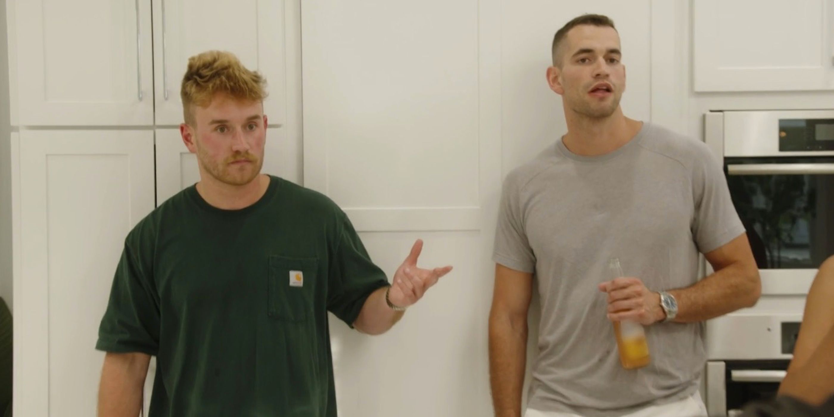West Wilson and Jesse Solomon look stunned in the kitchen of 'Summer House'