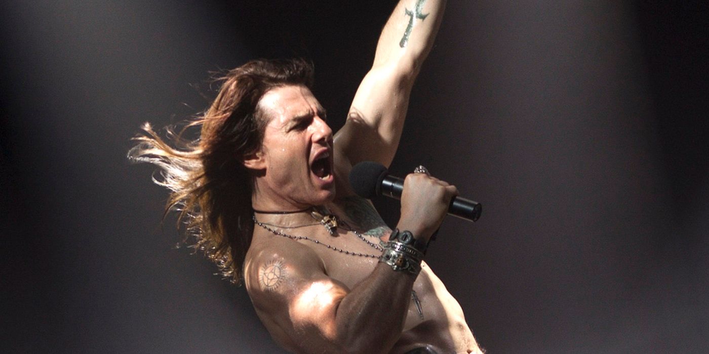 Tom Cruise as Stacee Jaxx rocking out on stage in a Rock of Ages promotional photo