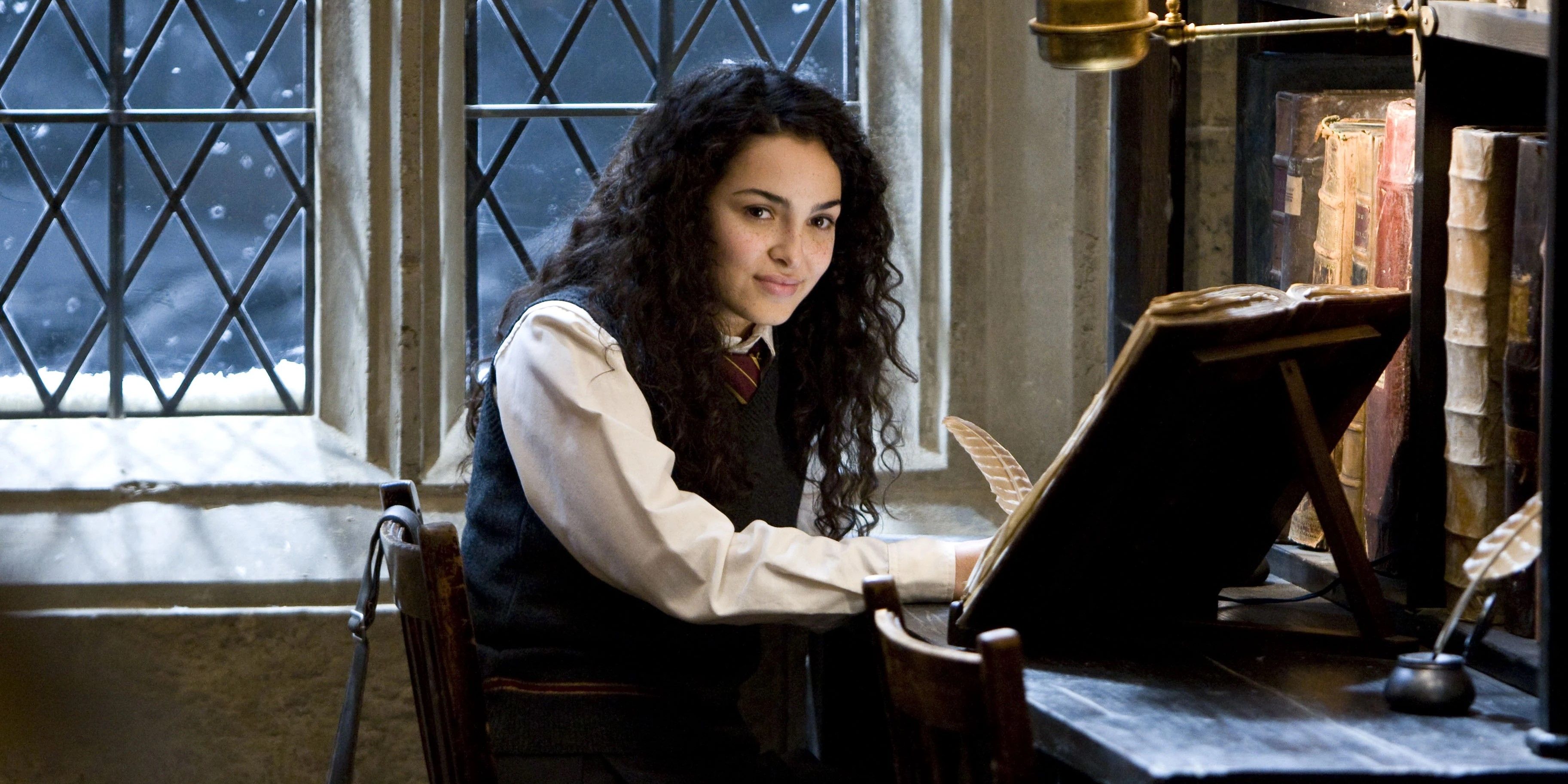 Romilda-Vane smiling and looking intently at something off camera in Harry Potter and the Half-Blood Prince