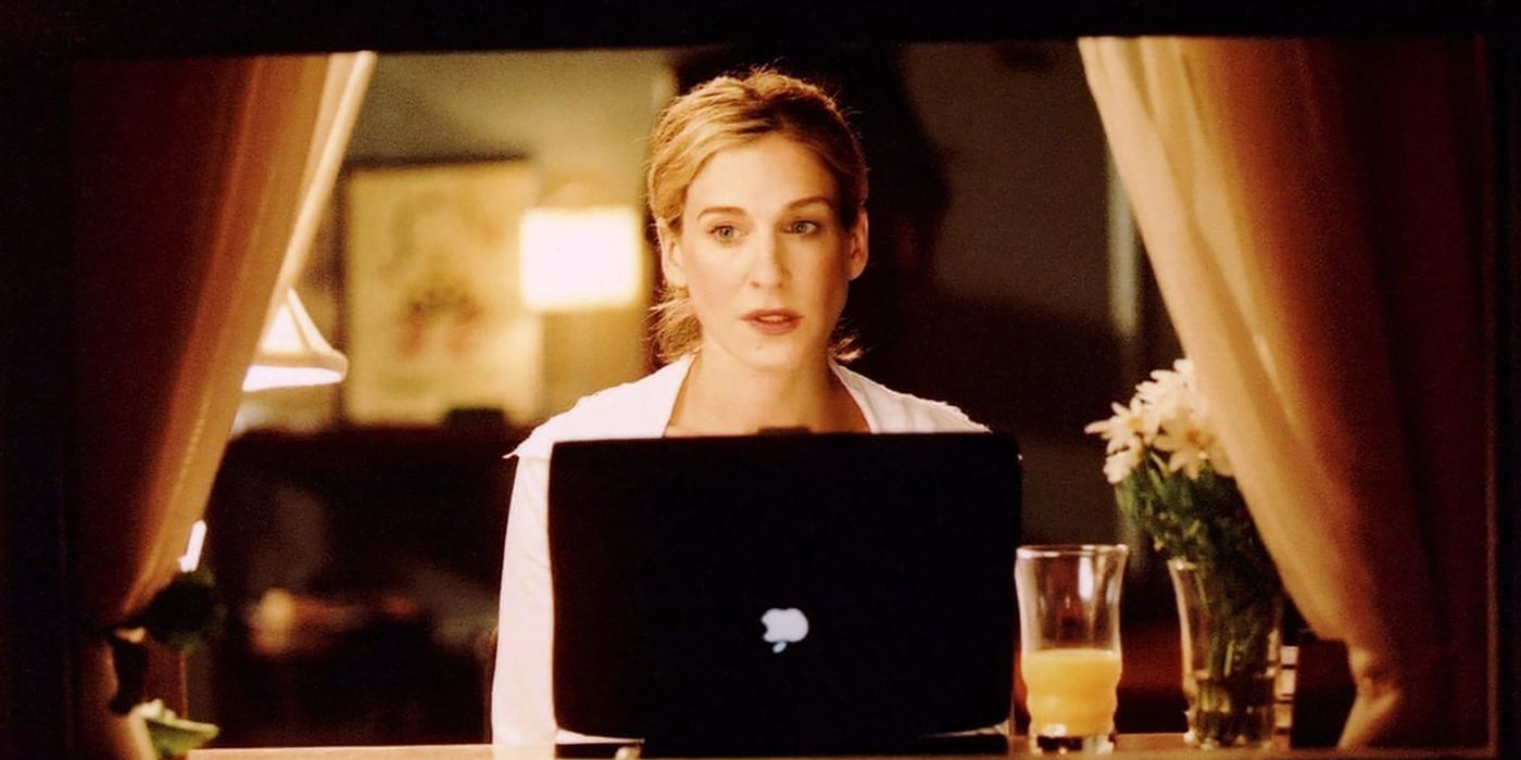 Carrie on her computer in front of the window looking pensive on Sex and the City.