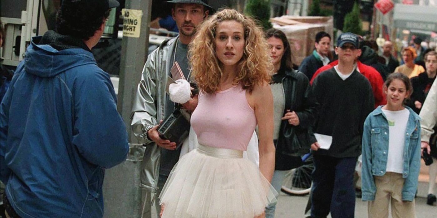 Carrie surrounded by people in the streets wearing the iconic tutu from the intro sequence on Sex and the City.