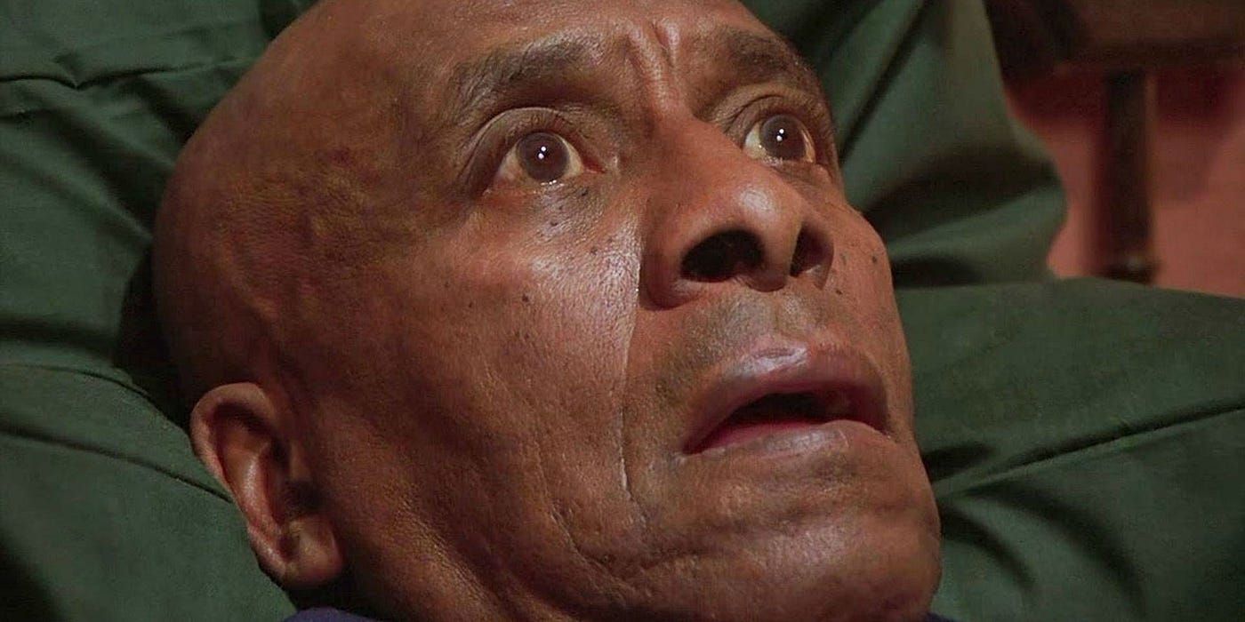 Scatman Crothers as Dick Hallorann lying in bed and staring at the ceiling in The Shining